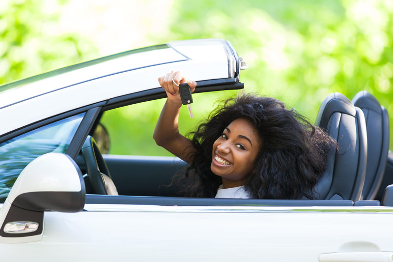 Young woman excited about new car